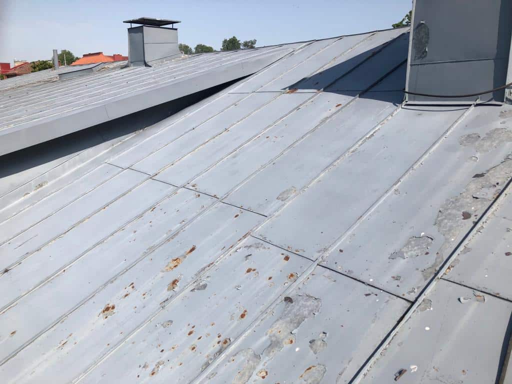 Taloyhtiön peltikattoreferenssi Pitkäkatu 20 Tammisaari ennen pesua ja maalausta